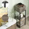 A narrow side table with a turntable on top, placed next to a television stand. Produktbild-Vorschau