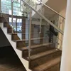 A modern staircase with glass railings and wooden steps. Anteprima dell’immagine prodotto