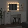 A vanity table with a lighted mirror and a stool in a room. Produktbild-Vorschau