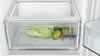 Close-up view of an open refrigerator drawer containing fresh fruits and vegetables. Produktbild-Vorschau