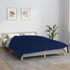 A bedroom scene with a bed covered by a navy blue blanket. Náhled obrázku produktu