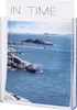 A clear plastic brochure holder displaying a scenic image of a rocky coastline and the sea. The text "IN TIME" is visible at the top of the paper inside the holder. Produktbild-Vorschau