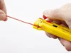 A hand holding a yellow wire stripper tool with a red wire being inserted. Produktbild-Vorschau
