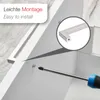 Close-up of a screwdriver being used to install a cabinet handle on a white surface. Produktbild-Vorschau