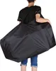 A person carrying a large black bag over their shoulder. Náhľad obrázku produktu