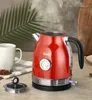 A red electric kettle is steaming on a countertop next to a white mug. Podgląd zdjęcia produktu