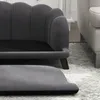 A close-up view of a dark gray pet sofa with a scalloped backrest and a separate ottoman in the foreground. Podgląd zdjęcia produktu