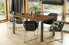 A dining table and chairs set in a modern dining room with large windows overlooking a garden. Anteprima dell’immagine prodotto