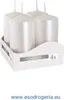Four white pillar candles in a white cardboard holder. Anteprima dell’immagine prodotto