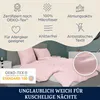 A bed with pink bedding, featuring marketing icons and text highlighting product features. Produktbild-Vorschau