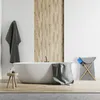 A modern bathroom with a freestanding bathtub, wooden wall paneling, and a laundry basket. Náhled obrázku produktu