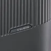 A close-up of a textured gray suitcase with the brand logo. Produktbild-Vorschau
