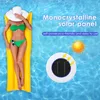 A woman in a bikini is relaxing on a yellow inflatable raft in a swimming pool, with a solar panel device floating nearby. Náhled obrázku produktu