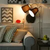 A cozy living room scene with a sofa, pillows, and a floor lamp. Anteprima dell’immagine prodotto