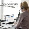 A woman wearing a headset is working on a laptop in an office setting. Produktbild-Vorschau