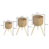 Three woven plant pots of varying sizes are displayed on wooden stands, with dimensions indicated by measurement lines and text. Produktbild-Vorschau