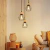 A cozy living room scene with pendant lights, a woven basket, and a wooden chair with cushions. Voir les images du produit
