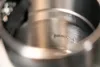 Close-up view of the interior of a metal kettle with text embossed on it. Podgląd zdjęcia produktu