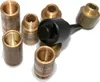 A collection of metal threaded fittings and a black tool on a white background. Podgląd zdjęcia produktu