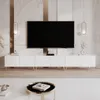 A white TV lowboard with gold legs in a modern living room setting. Voir les images du produit