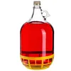 A glass jug filled with red liquid, with a yellow protective base. Voir les images du produit
