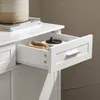 A close-up view of an open drawer in a white cabinet, revealing some items inside. Produktbild-Vorschau