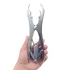 A hand holding a stainless steel castration tool against a white background. Produktbild-Vorschau