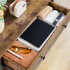 A close-up view of an open drawer on a wooden table, revealing various items inside. Produktbild-Vorschau