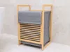 A laundry basket made of bamboo and gray fabric in a bathroom. Náhľad obrázku produktu