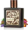 A bottle of Lattafa Qaed Al Fursan perfume is displayed on a white background, surrounded by aromatic ingredients. Voir les images du produit