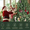 Santa Claus and two children decorating a Christmas tree indoors. Produktbild-Vorschau
