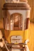 A close-up, slightly blurry shot of a wooden model tram on a wooden surface. Produktbild-Vorschau