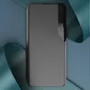 A dark gray flip case for a smartphone is displayed on a blue and teal background. Produktbild-Vorschau