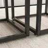 Close-up view of the metal legs of a table set on a carpeted floor. Podgląd zdjęcia produktu