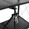 A close-up view of the black metal folding shelf's hinge mechanism and perforated shelf surface. Voir les images du produit