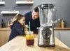 A father and daughter are in a kitchen, preparing a smoothie. Podgląd zdjęcia produktu