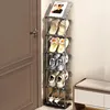 A multi-tiered shoe rack filled with various types of footwear is placed next to a door. Produktbild-Vorschau