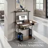 A computer desk setup in a modern room with natural light. Produktbild-Vorschau