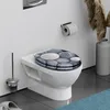 A toilet with a decorative seat cover in a bathroom setting. Anteprima dell’immagine prodotto