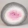A ball of yarn with a gradient of pink, white, and gray colors. Podgląd zdjęcia produktu
