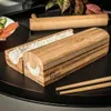 A sushi making set with rice in it, along with chopsticks, on a black tray. Náhľad obrázku produktu