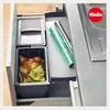 A kitchen drawer with a waste bin and rolls of foil. Anteprima dell’immagine prodotto