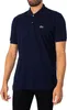 A man wearing a navy blue Lacoste polo shirt. Produktbild-Vorschau