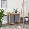 A bathroom or laundry room setting with a bamboo laundry basket and a plant. Produktbild-Vorschau