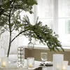 A table setting with a Christmas tree branch and decorative lights. Produktbild-Vorschau