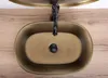 A top-down view of a rustic bronze basin with a black faucet. Náhľad obrázku produktu