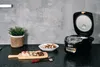 A kitchen scene with a rice cooker and sushi. Produktbild-Vorschau