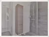 A modern bathroom with a tall cabinet and a shower. Produktbild-Vorschau