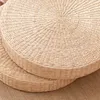 A close-up view of two round, woven straw floor cushions. Produktbild-Vorschau