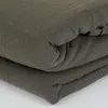 A stack of folded olive green fabric, likely bedding. Voir les images du produit